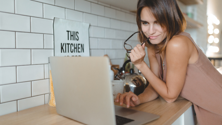 Woman with laptop in kitchen